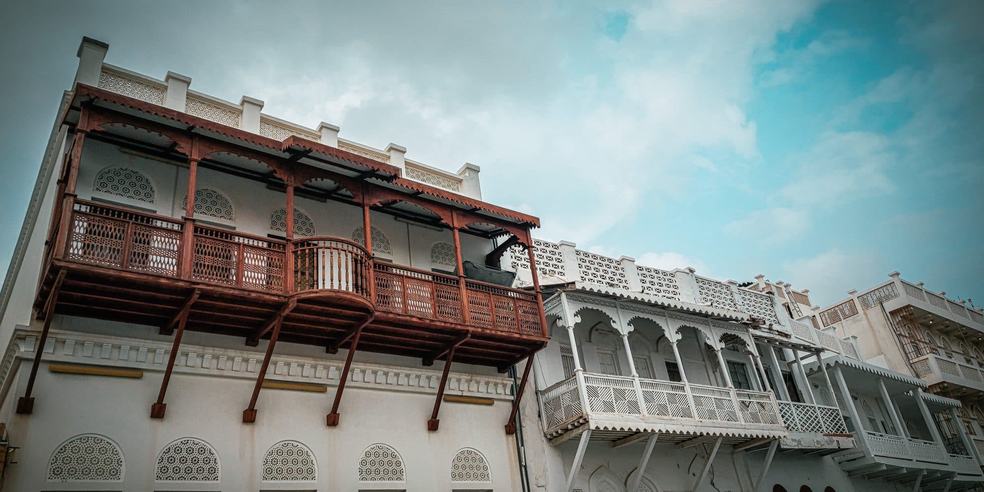 Carved wooden balconies on old merchant houses along Muttrah corniche